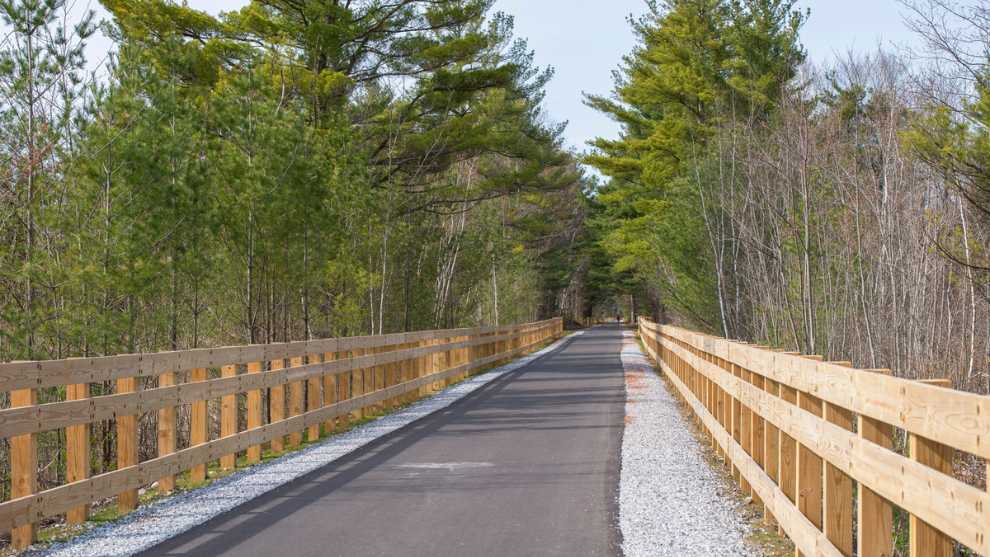 Greenway trail with fencing on either side