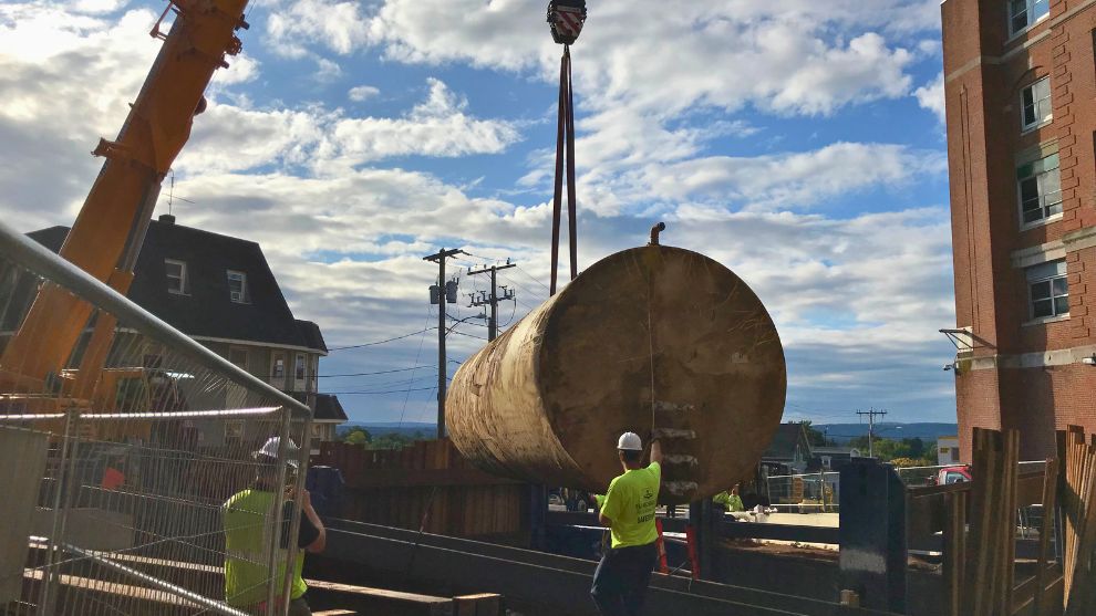 Underground storage tank being removed suspended in air