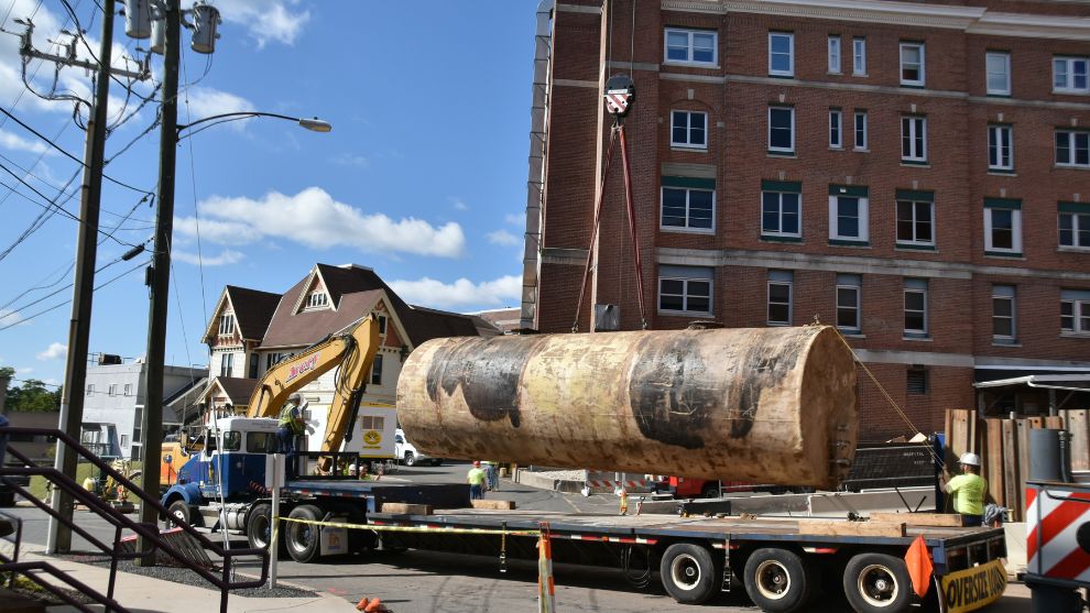 Underground storage tank is being taken away on flatbed truck