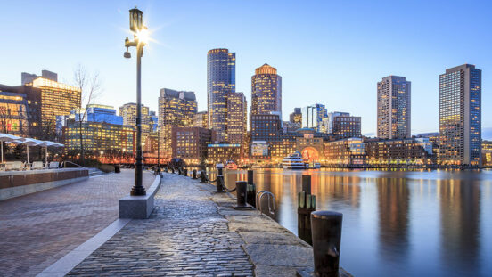 A dusk view of the city of Boston from the water
