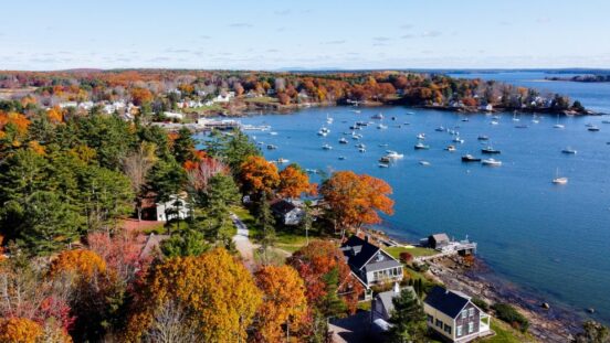 Aerial view of Kenny bunker main with boats in the water and fall foliage