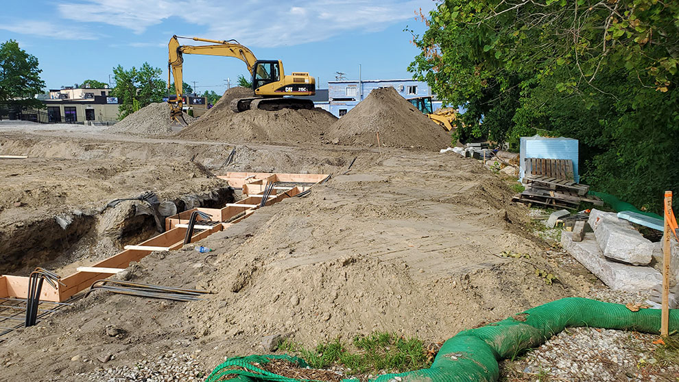 Excavator moving dirt at work site