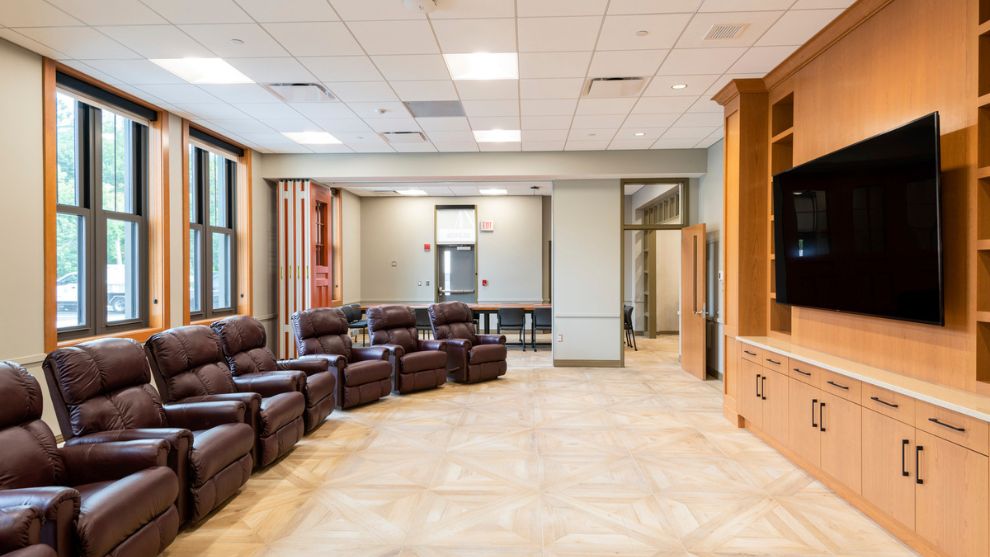 Firehouse interior recreation room with recliners and TV