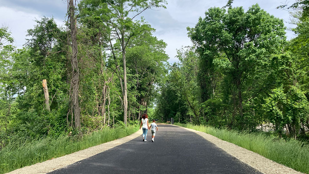 Two people walking on the completed it over trail