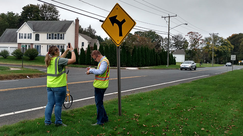 People in safety vests taking pictures of the project site