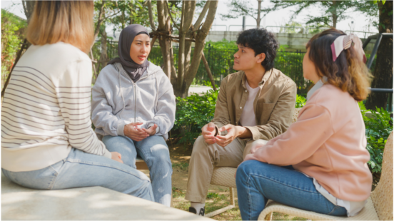 Four people sitting around chatting