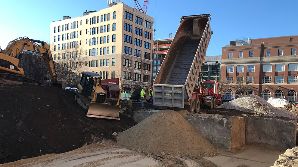 Dump truck dumping soil at the construction site