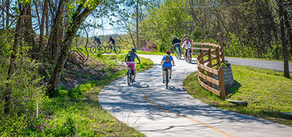People bike riding on a greenway trail