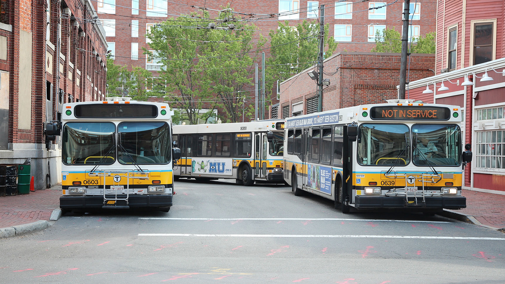 Three city buses parked on the street