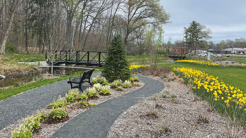 Park bench, path, bridge and flowers