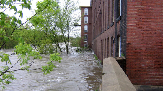 Flooded river up against a building