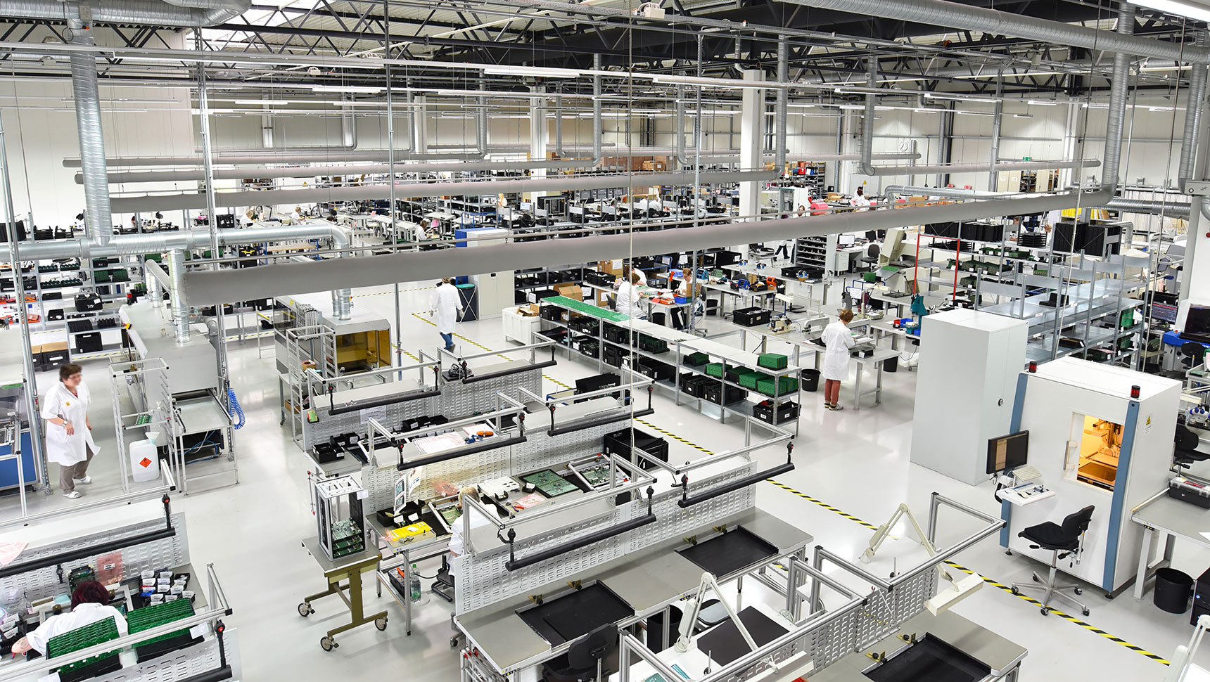 overhead view of factory floor with machinery and people