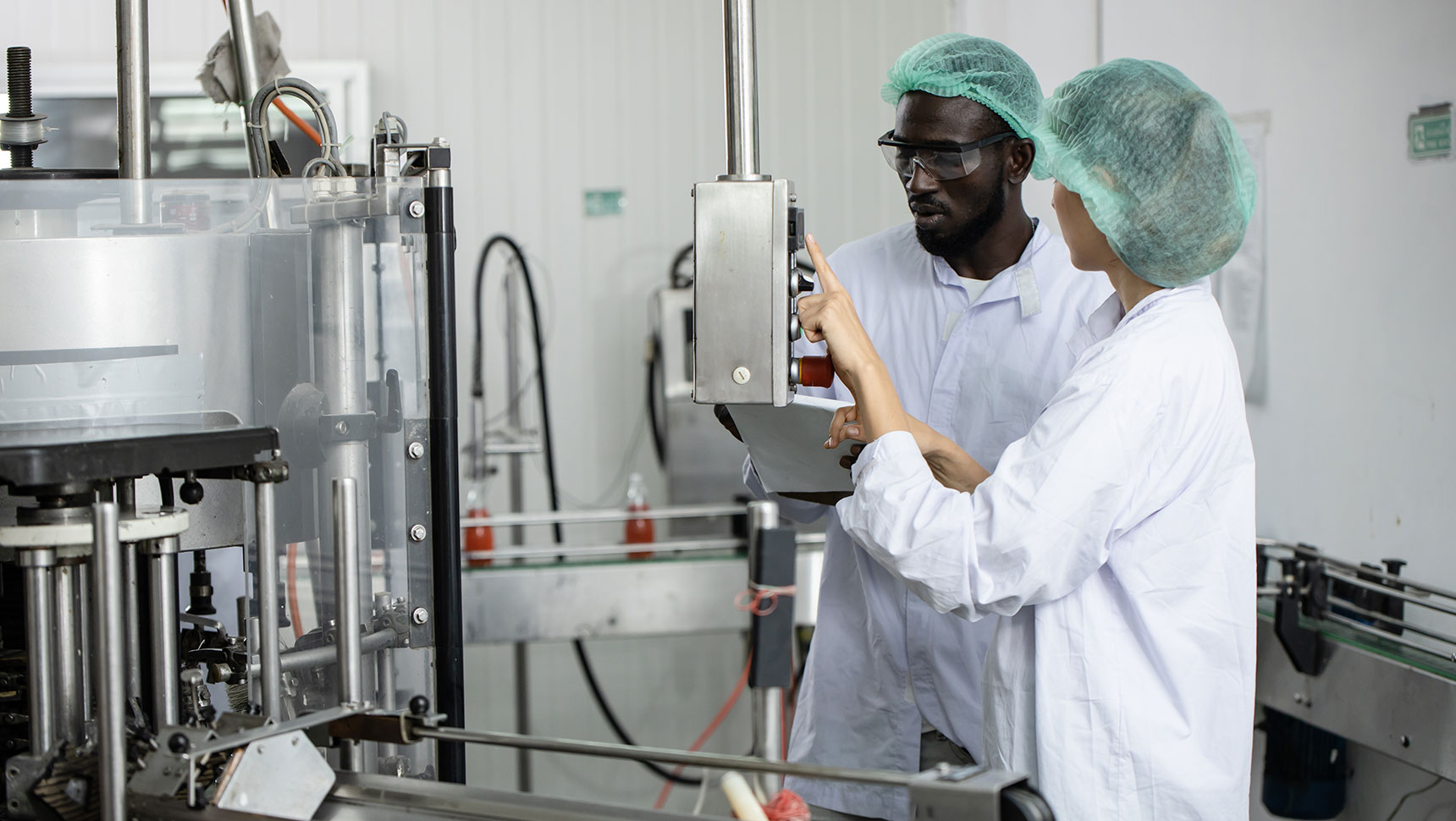 workers operating industrial food equipment