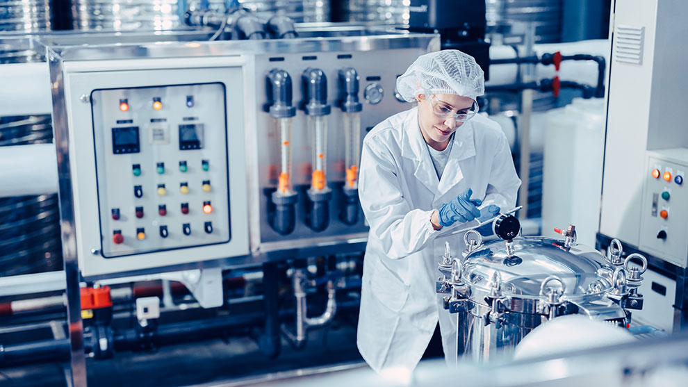 woman taking notes at industrial plant