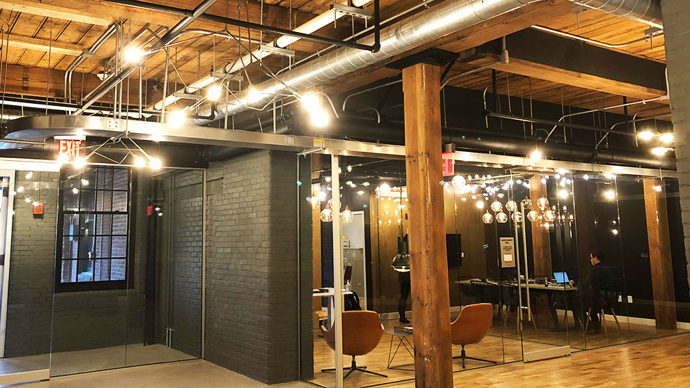 Finished interior view of Montgomery mill building with lights tables and chairs