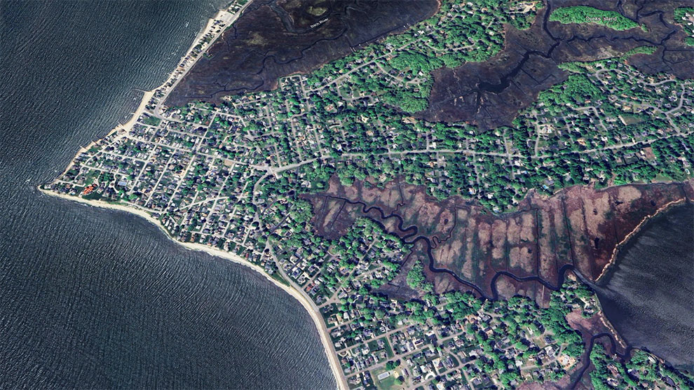 aerial view of the beach and neighborhood