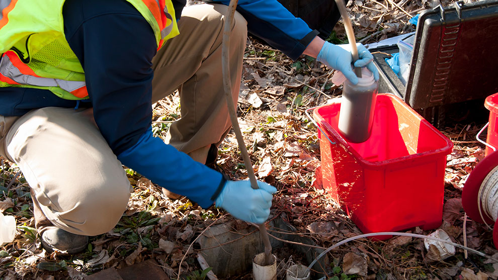 A person conducting Water sampling With equipment
