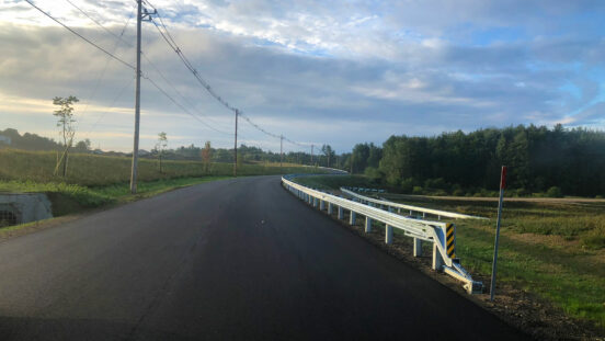 Newly paved roadway with guardrail