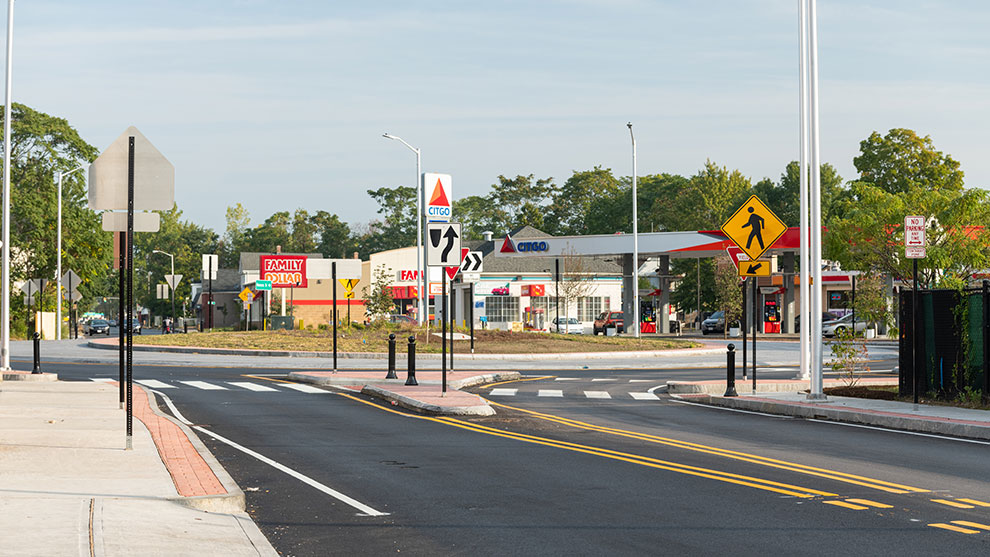 Road and street signs at six corners roundabout