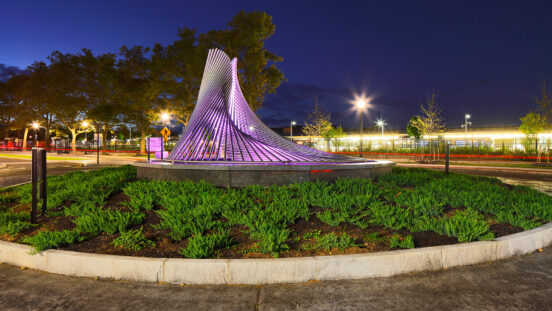 view of sculpture lit up at night in center of rotary
