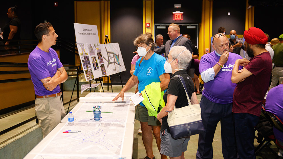 Wall street community event with the public talking with the project team